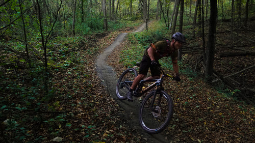 Man Riding on Mountain Bike Trail In The Woods
